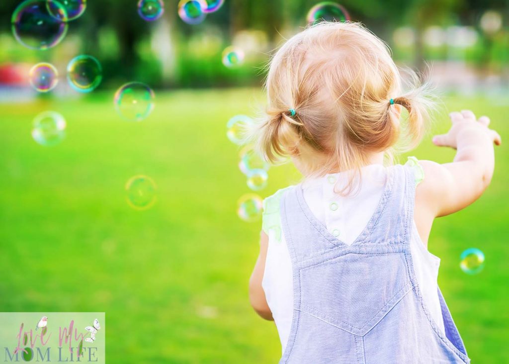 toddler chasing bubbles